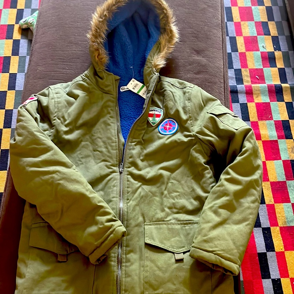 Boys army colored coat, with faux fur lined hood. Electric blue fleece on inside